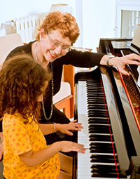 young girl enjoying her piano lesson