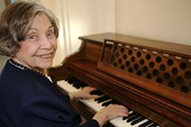 senior playing the piano