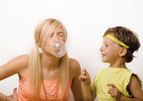 Mom blowing a bubble with her son
