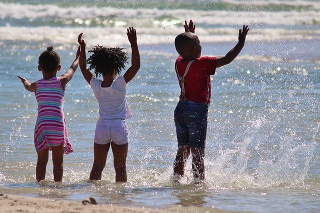 children in the waves at the beach