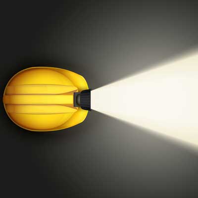 light on a miner's helmet showing the way